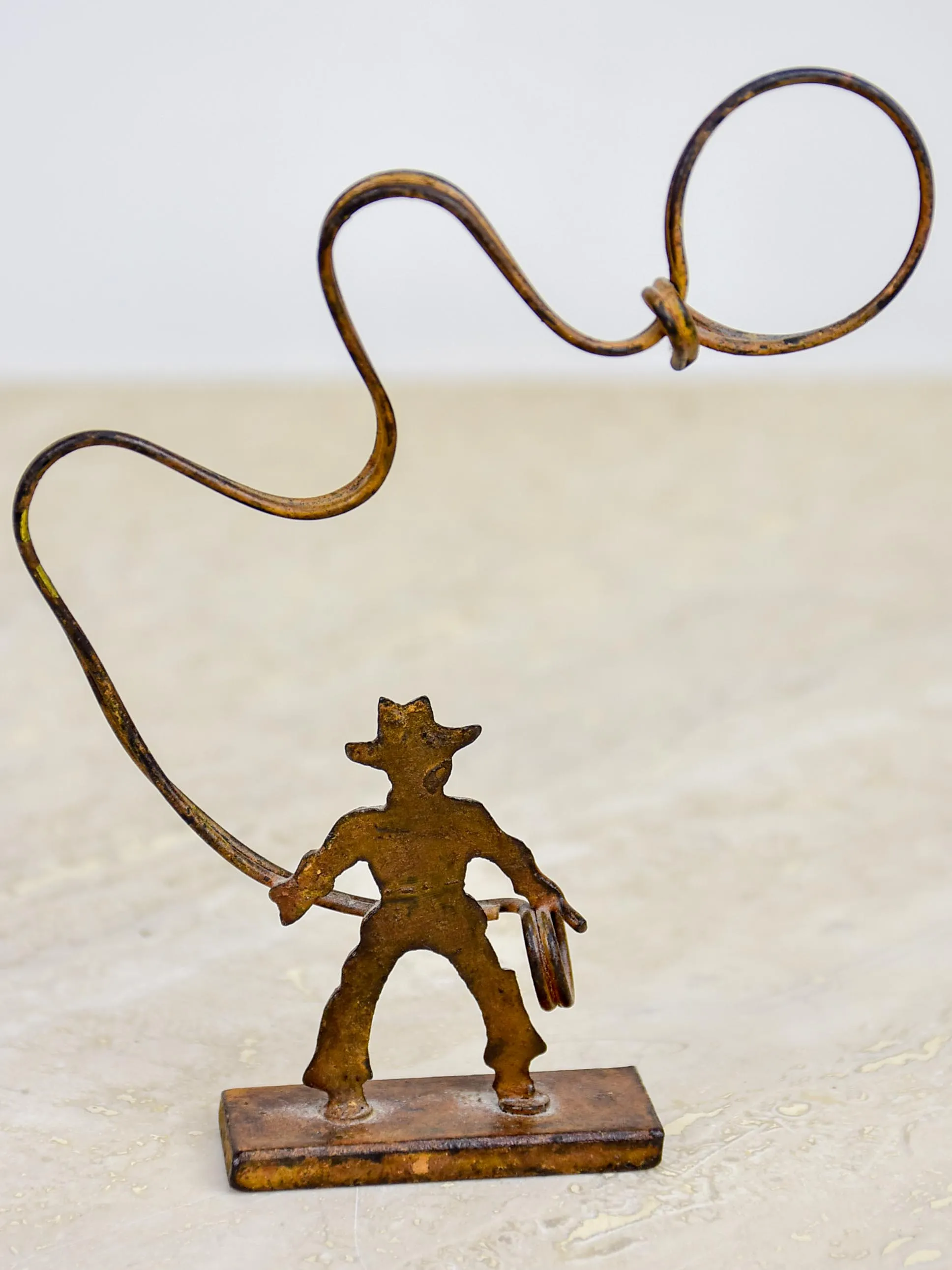 Antique cowboy lasso sculpture